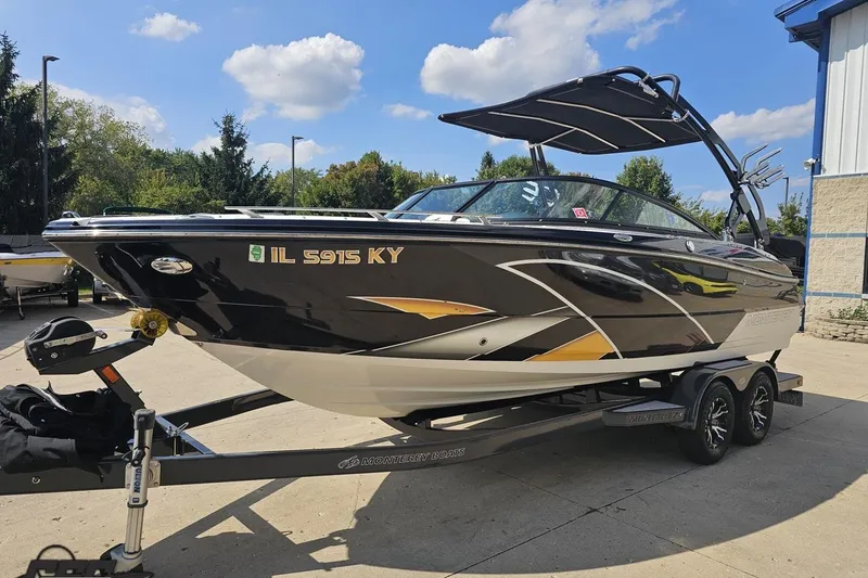 Slide: The Image of 2018 Monterey 238SS Super Sport boat on trailer, parked outdoors under blue sky. - 10
