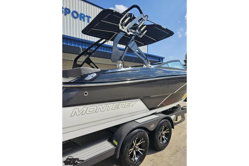 Slide: The Image of 2018 Monterey 238SS Super Sport boat on trailer, parked outside a building. - 18