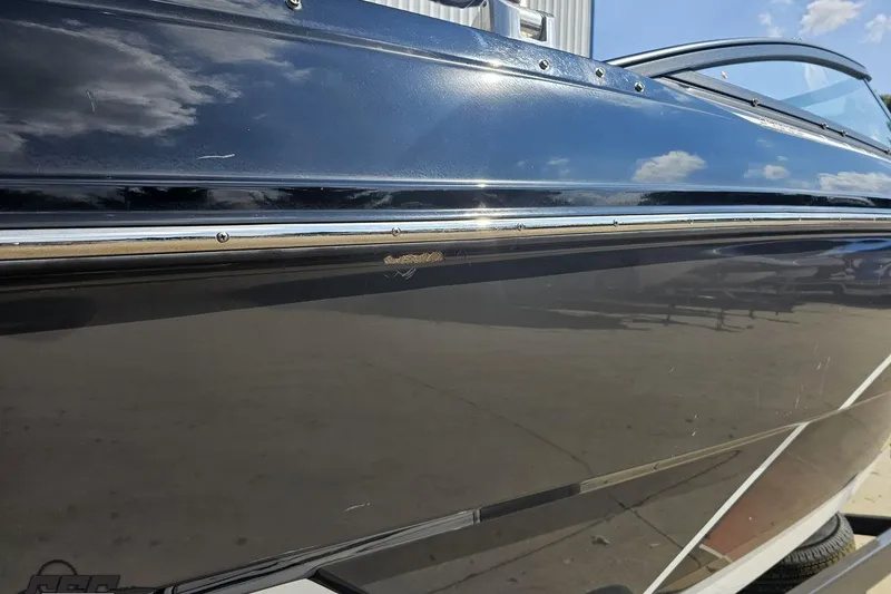 Slide: The Image of 2018 Monterey 238SS Super Sport boat with sleek black exterior and chrome detailing. - 19