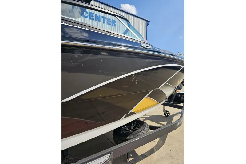 Slide: The Image of 2018 Monterey 238SS Super Sport boat with sleek black and yellow design. - 21