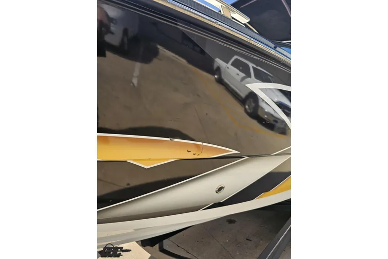 Slide: The Image of 2018 Monterey 238SS Super Sport boat with sleek black and gold exterior design. - 26