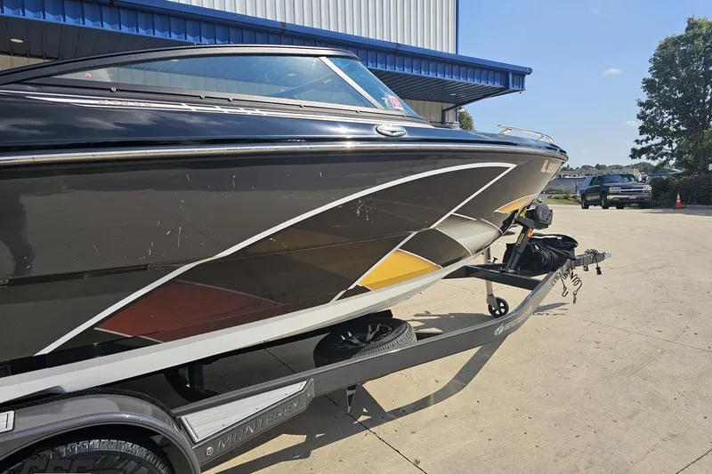 Slide: The Image of 2018 Monterey 238SS Super Sport boat on trailer, parked outside a building. - 3