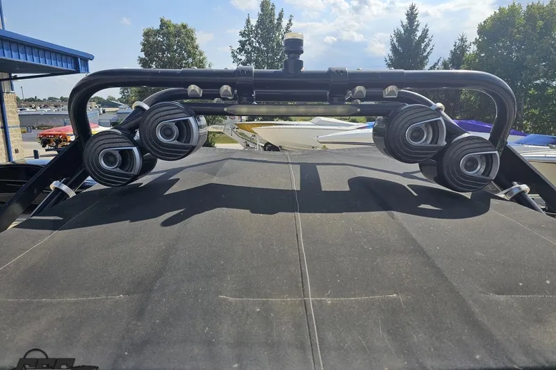 Slide: The Image of 2018 Monterey 238SS Super Sport boat with wakeboard tower and speakers, docked outdoors. - 33