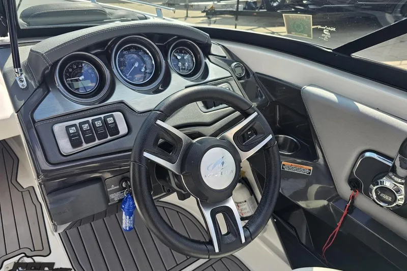 Slide: The Image of 2018 Monterey 238SS Super Sport boat dashboard with steering wheel and gauges. - 53