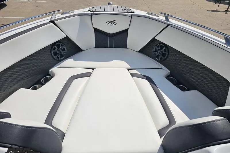 Slide: The Image of 2018 Monterey 238SS Super Sport boat interior with white and black seating, cup holders, and speakers. - 57