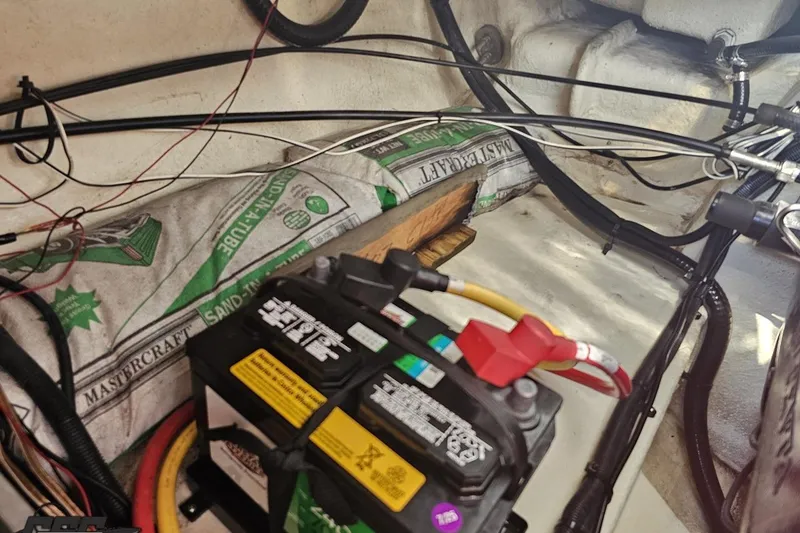 Slide: The Image of Battery compartment of 2018 Monterey 238SS Super Sport boat with wiring and sandbags. - 81