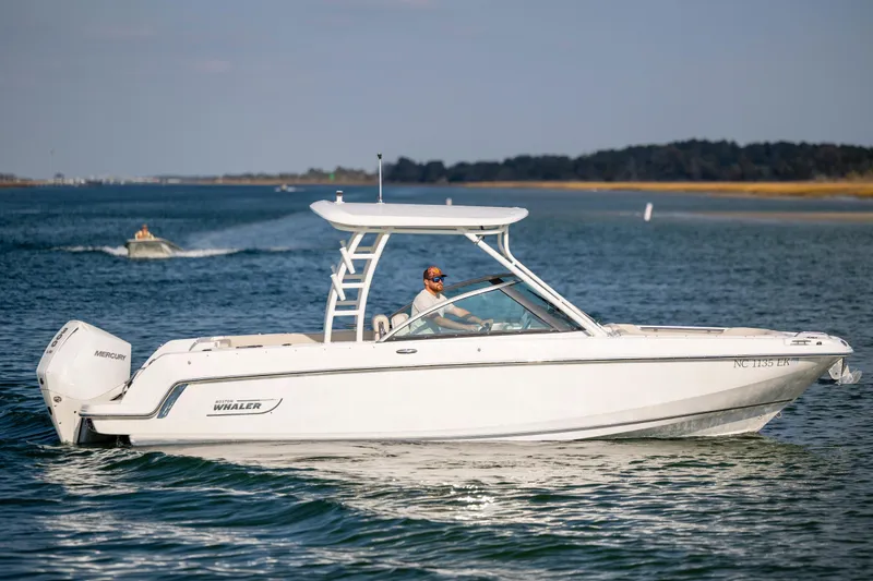 Slide: The Image of 2019 Boston Whaler 230 Vantage boat cruising on a calm lake. - 0