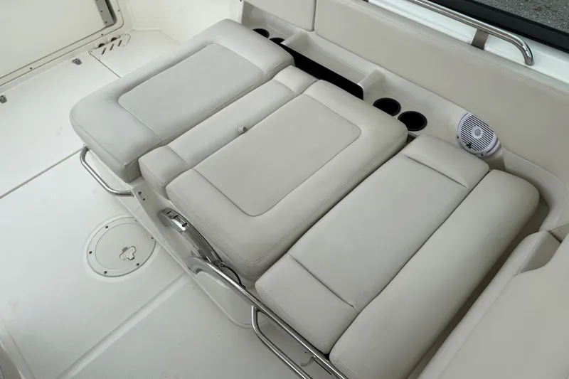 Slide: The Image of 2019 Boston Whaler 230 Vantage boat interior with seating, on calm water. - 19