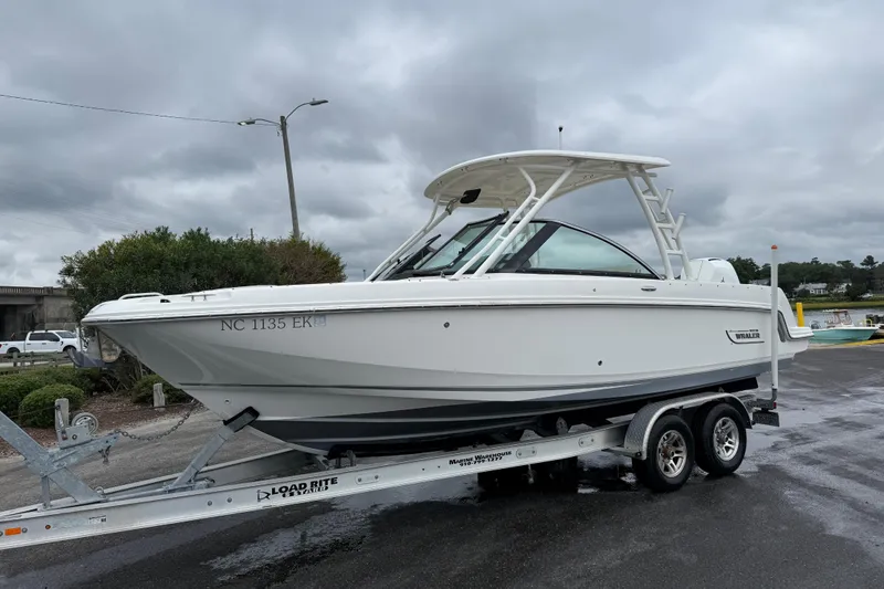 Slide: The Image of 2019 Boston Whaler 230 Vantage boat cruising on a serene waterway. - 2