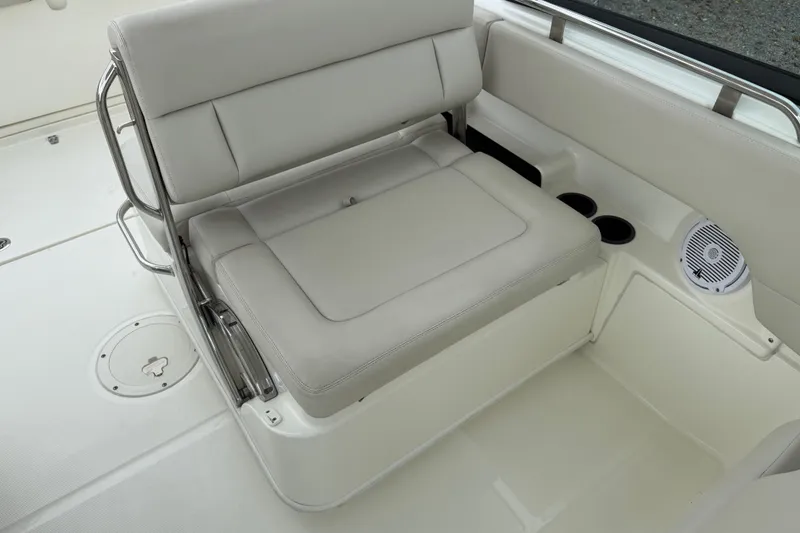 Slide: The Image of 2019 Boston Whaler 230 Vantage boat interior with steering wheel, seats, and open water view. - 20