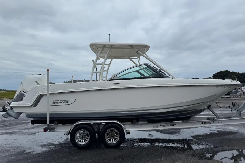 Slide: The Image of 2019 Boston Whaler 230 Vantage boat on calm water, rear view. - 8