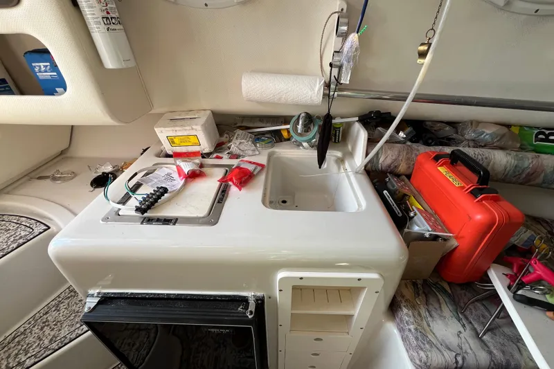 Slide: The Image of Interior of a 1994 Pro-Line 2950 boat with sink, tools, and storage. - 10