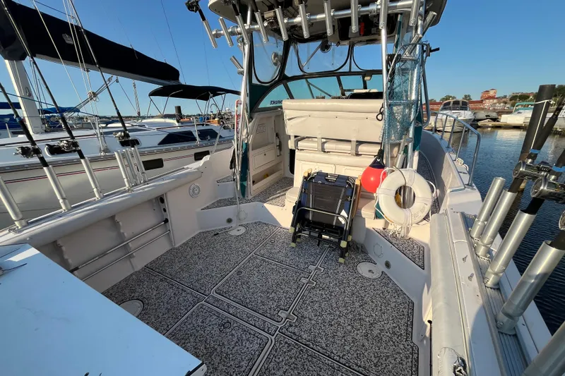Slide: The Image of 1994 Pro-Line 2950 boat interior with fishing gear and marina view. - 12