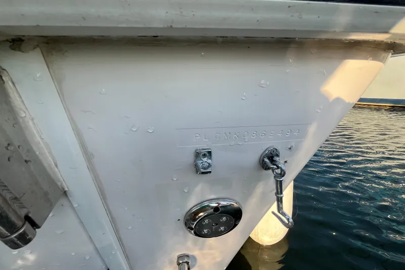 Slide: The Image of 1994 Pro-Line 2950 boat stern with identification number, docked on water. - 16