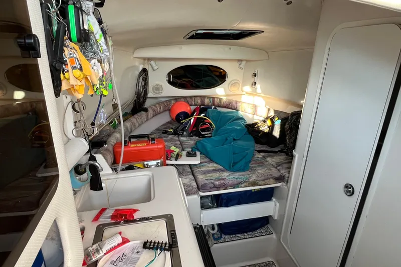 Slide: The Image of Interior of a 1994 Pro-Line 2950 boat cabin with fishing gear and equipment. - 9