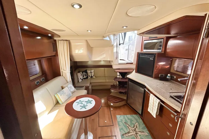 Slide: The Image of Luxurious interior of 2008 Sea Ray 38 Sundancer yacht with modern kitchen and seating area. - 10
