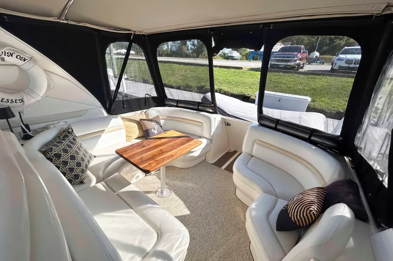 Slide: The Image of Luxurious interior of 2008 Sea Ray 38 Sundancer yacht with plush seating and wooden table. - 2