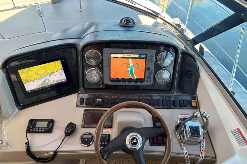 Slide: The Image of Helm of 2008 Sea Ray 38 Sundancer with navigation screens and controls. - 4