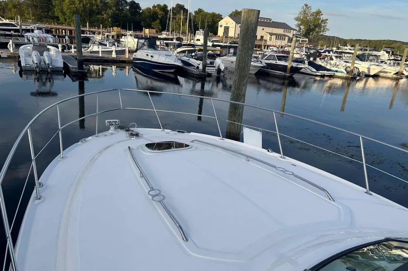 Slide: The Image of 2008 Sea Ray 38 Sundancer yacht docked at a marina with other boats. - 6