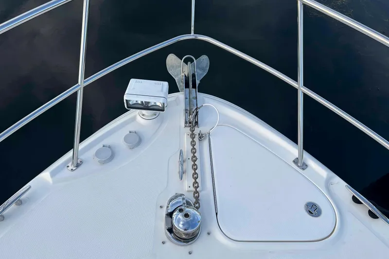 Slide: The Image of Bow of 2008 Sea Ray 38 Sundancer with anchor and railing, on calm water. - 7