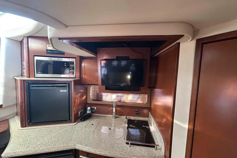 Slide: The Image of 2008 Sea Ray 38 Sundancer interior with kitchenette, TV, and microwave. - 9