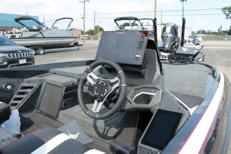 Slide: The Image of 2026 Skeeter FXR20 FLEX boat interior with steering wheel and navigation system. - 10