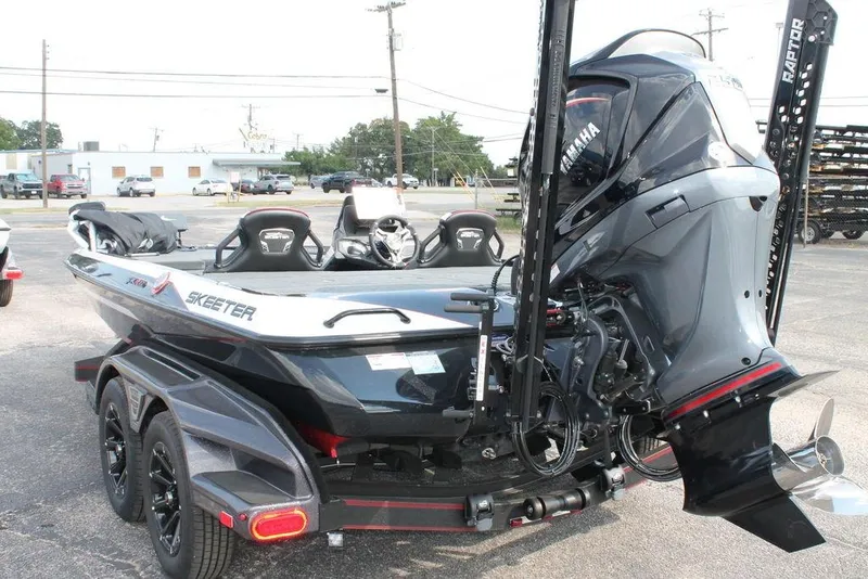 Slide: The Image of 2026 Skeeter FXR20 FLEX boat with Yamaha engine, parked on a trailer in a lot. - 8