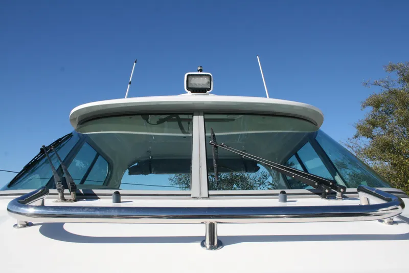 Slide: The Image of 2012 Protector Targa 30 boat on trailer, parked outdoors, with "For Sale" sign. - 1