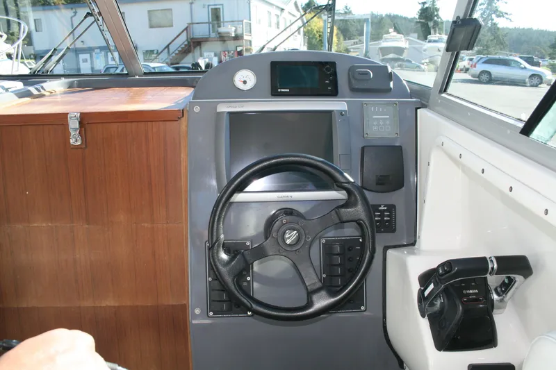 Slide: The Image of Boat dashboard with Fusion stereo and Garmin VHF radio on a 2012 Protector Targa 30. - 4