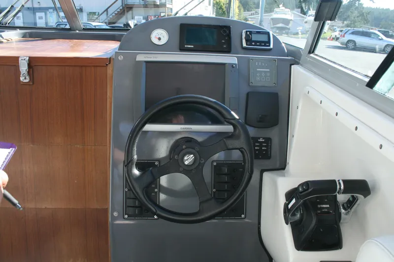 Slide: The Image of 2012 Protector Targa 30 boat helm with steering wheel and navigation controls. - 5