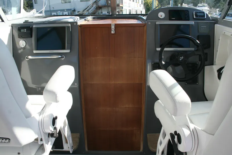 Slide: The Image of Control panel of a 2012 Protector Targa 30 boat with Garmin GPS system. - 9