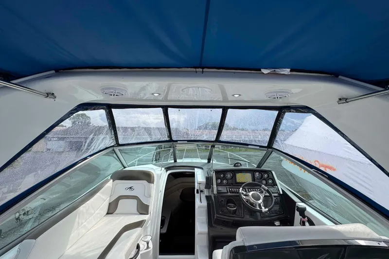 Slide: The Image of Interior view of 2019 Monterey 295 Sport Yacht cockpit with steering wheel and seating. - 12