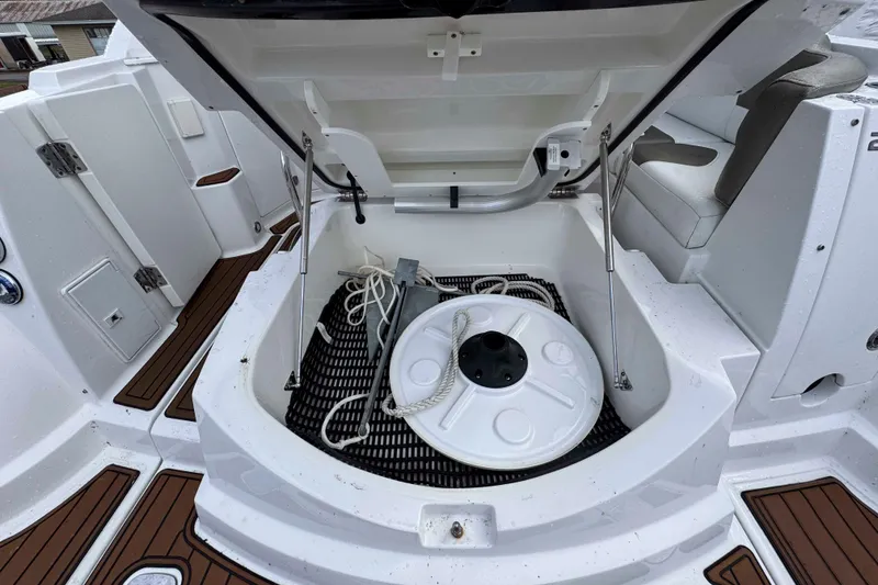 Slide: The Image of Open storage compartment on 2019 Monterey 295 Sport Yacht with ropes and equipment. - 13