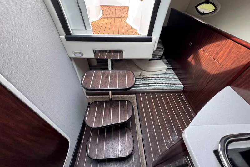 Slide: The Image of Interior of 2019 Monterey 295 Sport Yacht with wooden steps and flooring. - 18