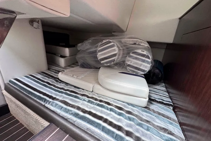 Slide: The Image of Interior cabin of 2019 Monterey 295 Sport Yacht with striped bedding and cushions. - 19