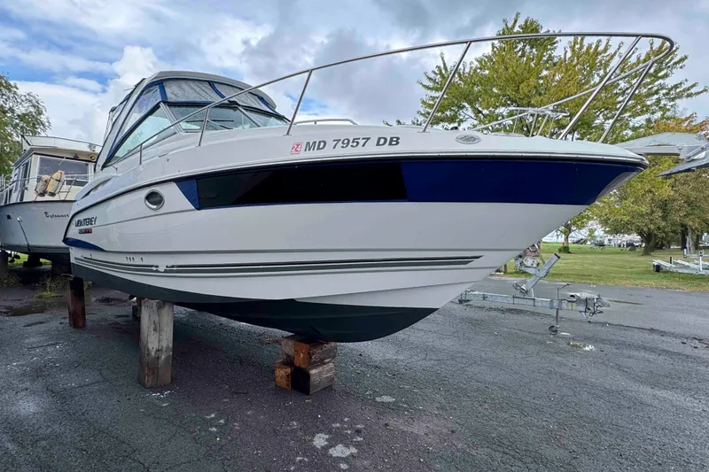 Slide: The Image of 2019 Monterey 295 Sport Yacht on dry dock, showcasing sleek design and modern features. - 2