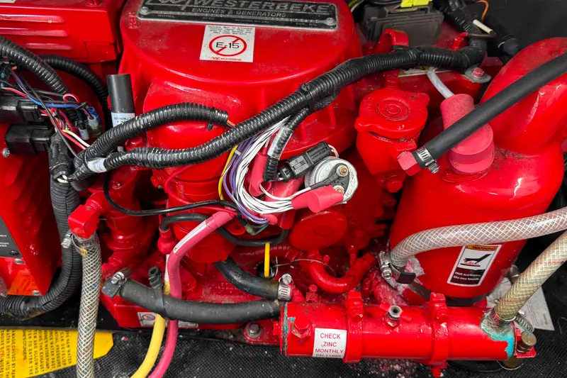 Slide: The Image of Engine compartment of a 2019 Monterey 295 Sport Yacht with red components and wiring. - 29