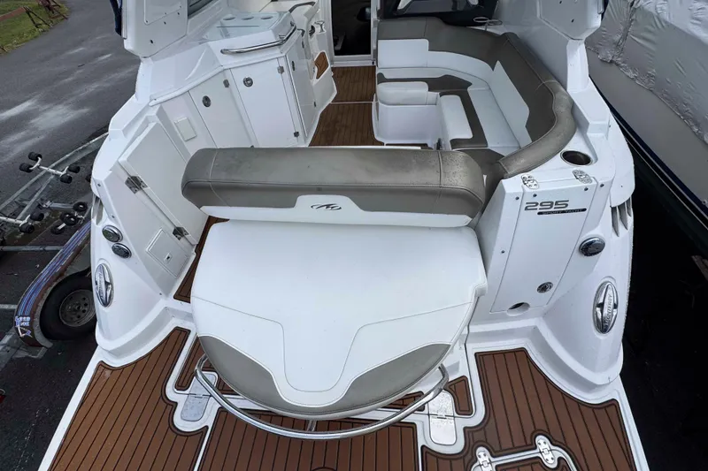 Slide: The Image of 2019 Monterey 295 Sport Yacht interior with seating and deck view. - 7