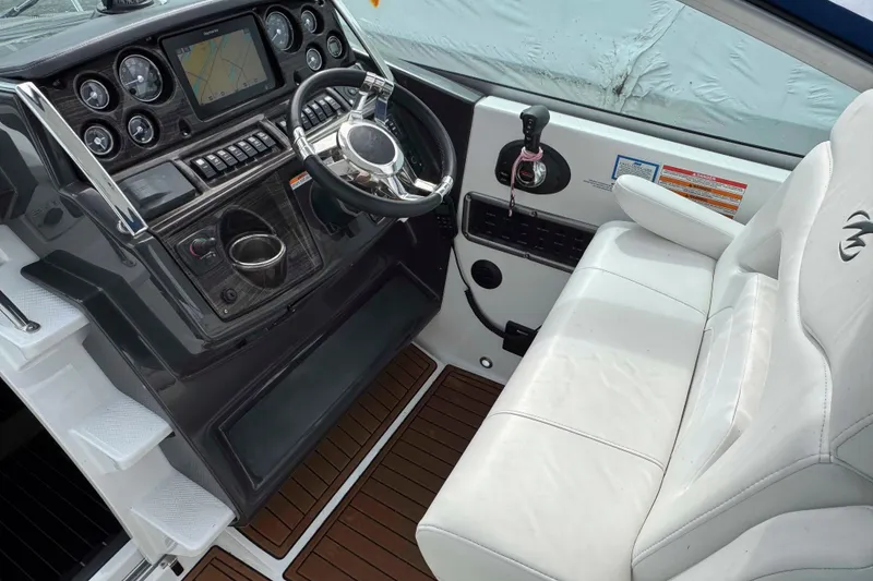 Slide: The Image of Cockpit of 2019 Monterey 295 Sport Yacht with steering wheel and navigation system. - 8
