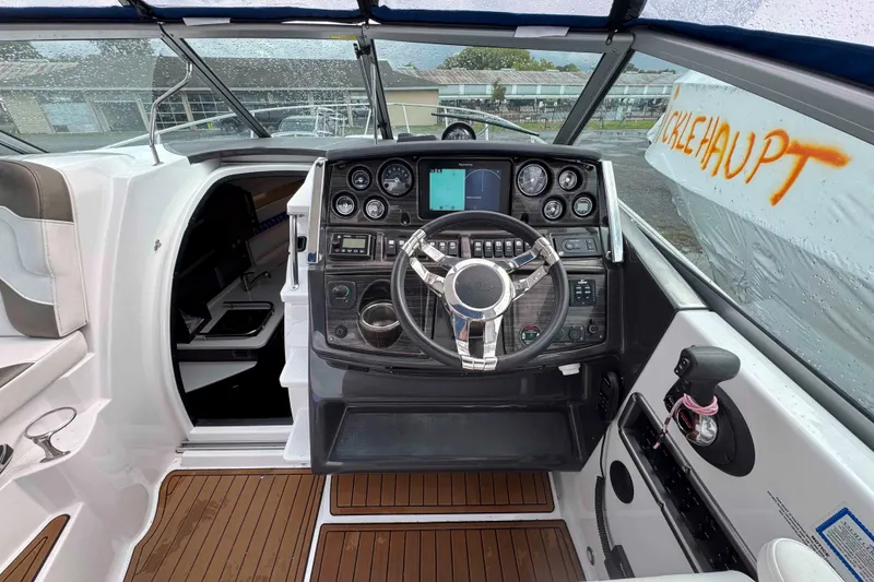Slide: The Image of 2019 Monterey 295 Sport Yacht cockpit with modern controls and sleek design. - 9