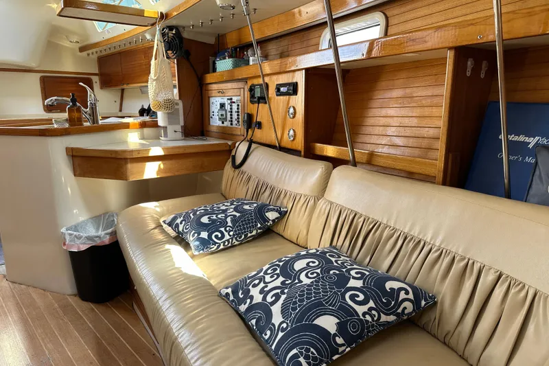 Slide: The Image of Interior of a 1995 Catalina 320 sailboat with cozy seating and nautical decor. - 11
