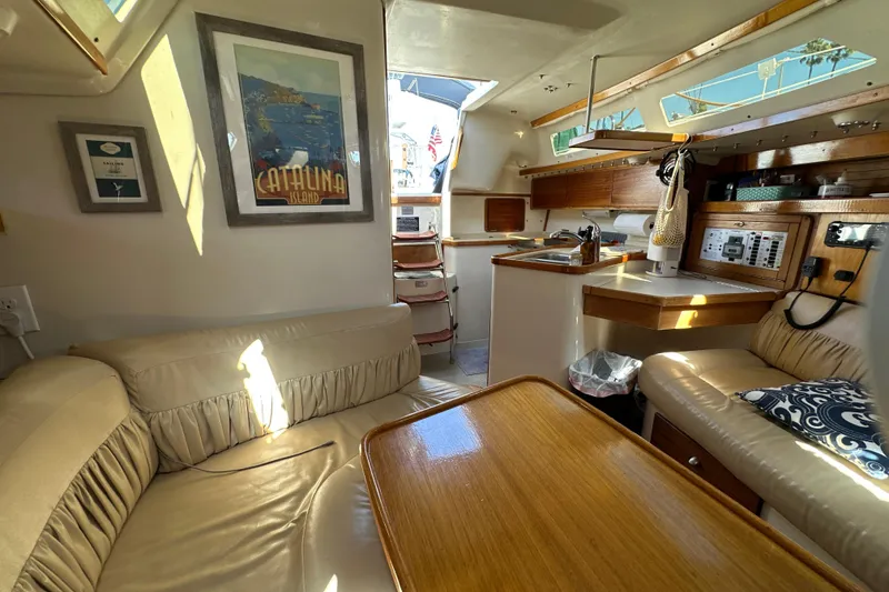 Slide: The Image of Interior of a 1995 Catalina 320 sailboat with cozy seating and nautical decor. - 12