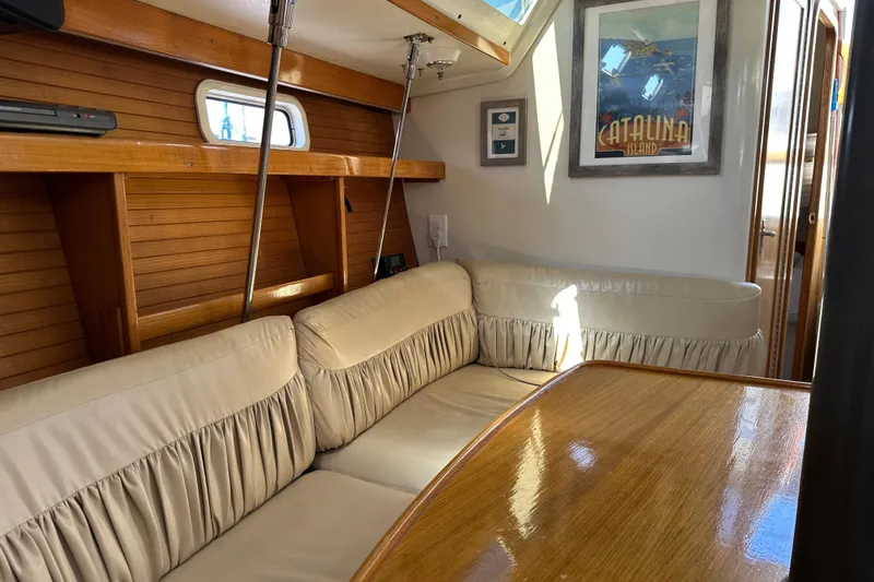 Slide: The Image of Interior of a 1995 Catalina 320 sailboat with cozy seating and wooden accents. - 13