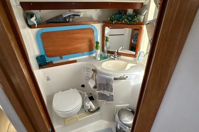 Slide: The Image of Compact bathroom in a 1995 Catalina 320 sailboat with sink, toilet, and mirror. - 20
