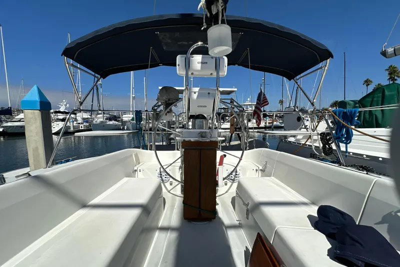 Slide: The Image of Cockpit view of a 1995 Catalina 320 sailboat docked in a marina. - 29