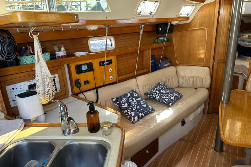 Slide: The Image of Interior of a 1995 Catalina 320 sailboat with cozy seating and nautical decor. - 3