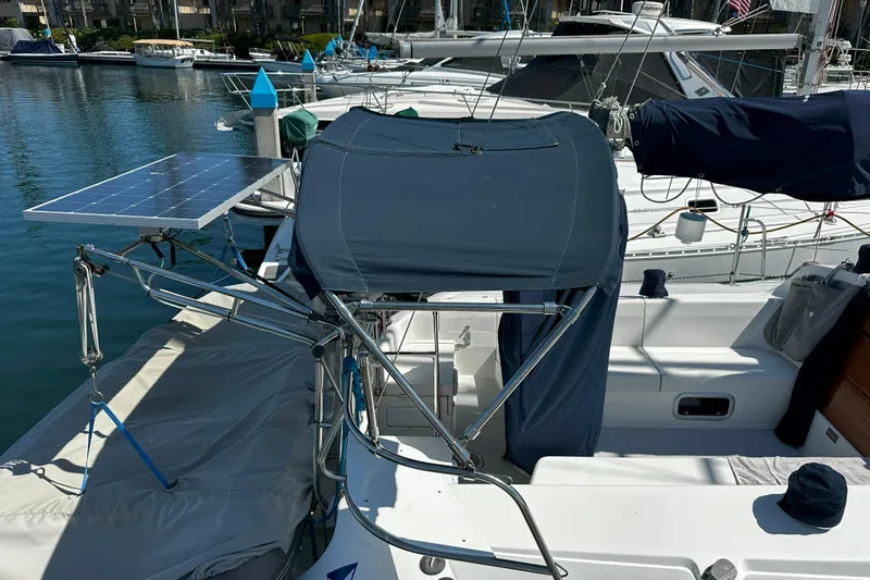 Slide: The Image of 1995 Catalina 320 sailboat with solar panel and covered cockpit in marina. - 35