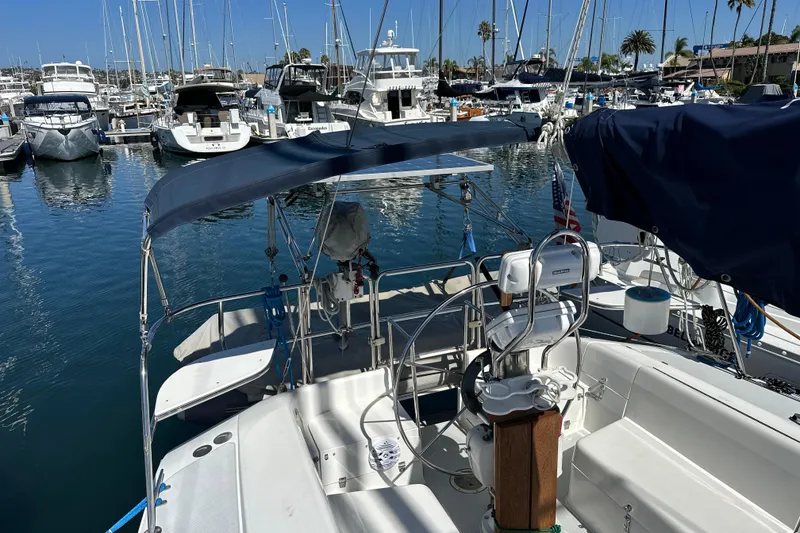 Slide: The Image of Sailboat Catalina 320, 1995 model, docked in a marina with other boats. - 37