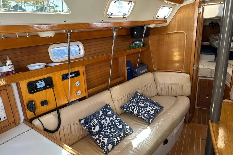 Slide: The Image of Interior of a 1995 Catalina 320 sailboat with beige seating and nautical decor. - 4