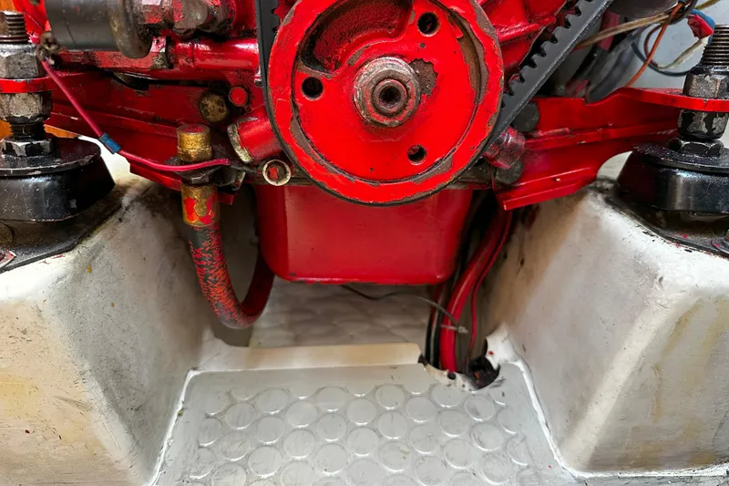 Slide: The Image of Close-up of a red engine component in a 1995 Catalina 320 sailboat. - 45